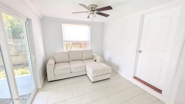 a spacious bedroom with a bed and a window