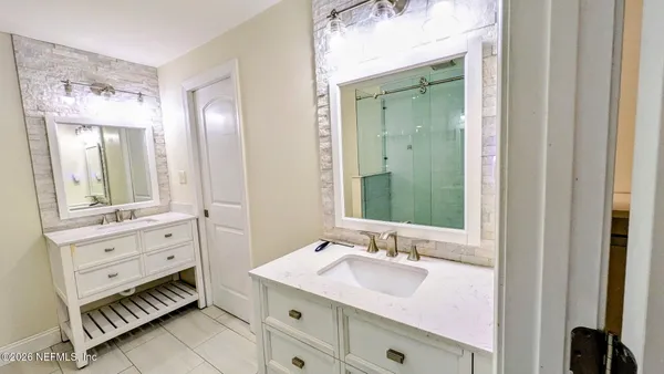 a bathroom with a sink double vanity and a mirror