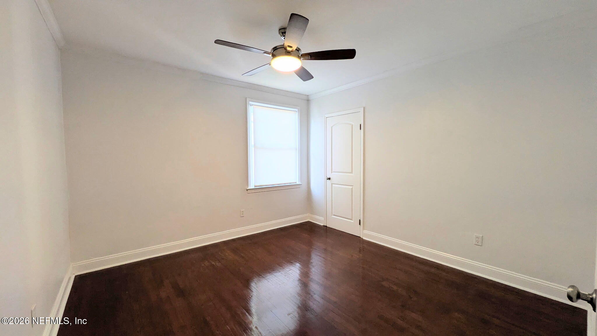 1218 Dancy Street Jacksonville, FL 32205 - Photo 19 of 19 an empty room with wooden floor and ceiling fan