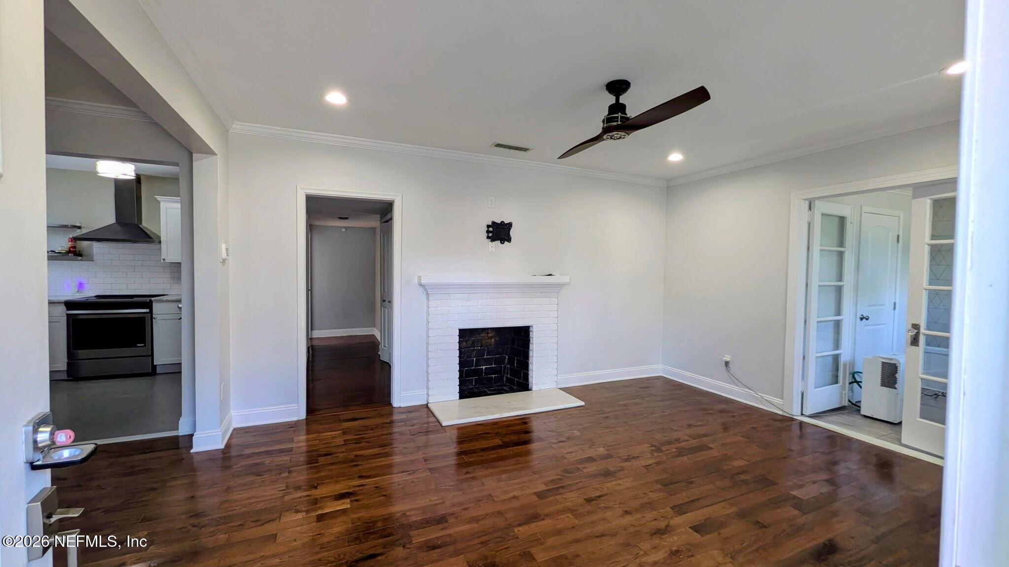 1218 Dancy Street Jacksonville, FL 32205 - Photo 4 of 19 an empty room with fireplace and wooden floor