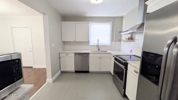 a kitchen with a sink a washer and dryer