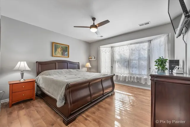 a bedroom with a bed and a large window