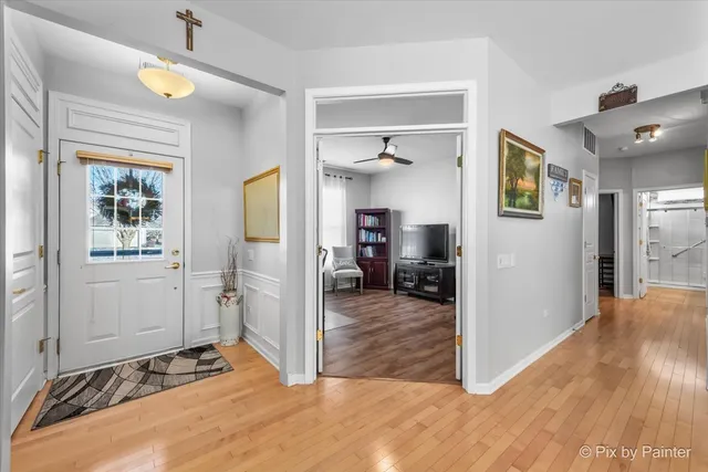 a view of a bedroom with wooden floor and window