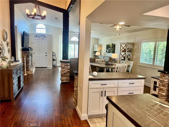 a living room with furniture a window and kitchen view
