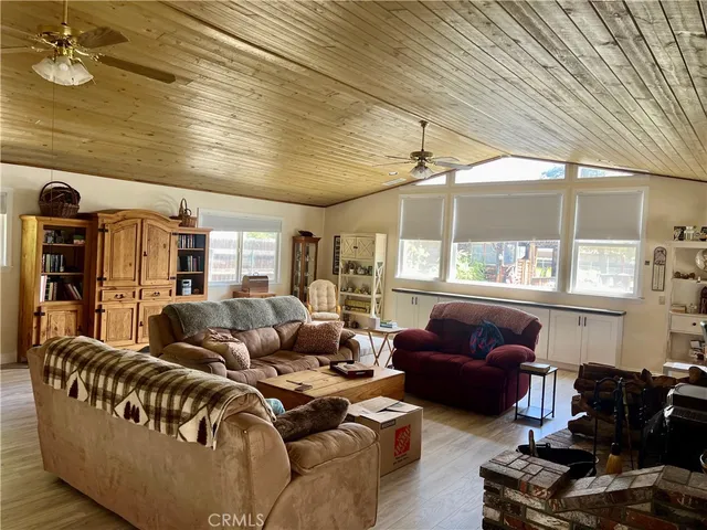 a kitchen with stainless steel appliances granite countertop a sink a stove white cabinets a dining table and chairs