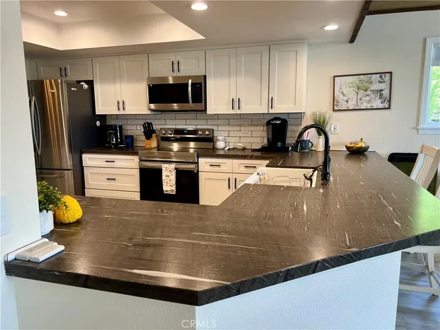 a view of a bathroom with a toilet a sink and mirror