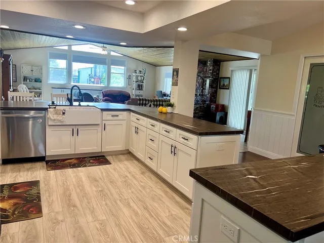 a bed sitting in a bedroom next to a lamp