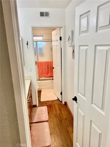 a bed sitting in a bedroom next to a lamp