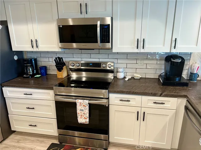 a view of a cafe with a table and chairs in front of it