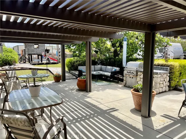 a view of a house with backyard and sitting area