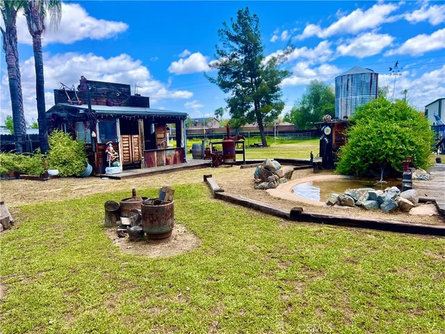 a view of a swimming pool with a lawn chairs with plants