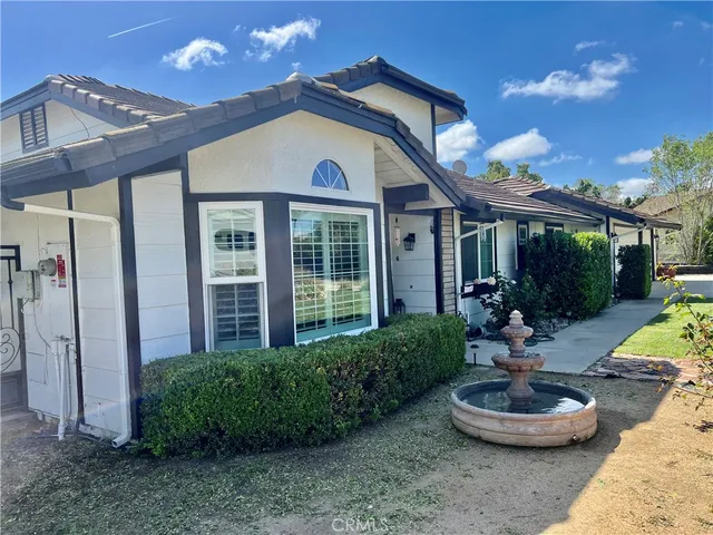 a front view of a house with a yard patio and fire pit