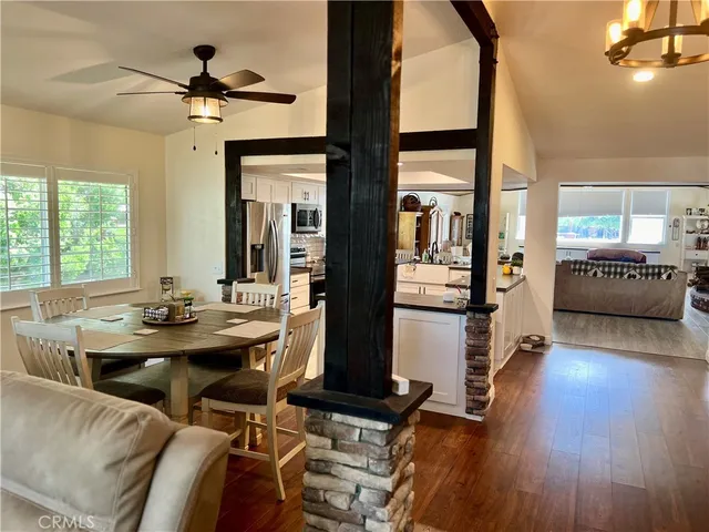 a view of a hallway with wooden floor and windows
