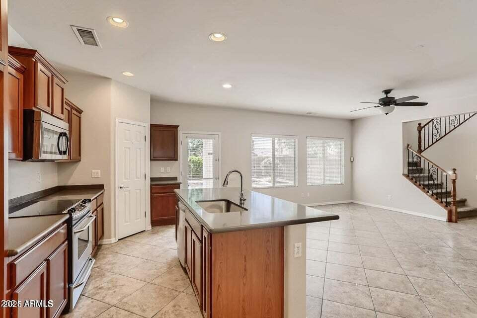 2039 West Kathleen Road Phoenix, AZ 85023 - Photo 8 of 33 a kitchen that has a sink a stove and a refrigerator