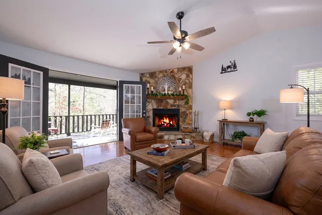 a living room with furniture ceiling fan and a fireplace