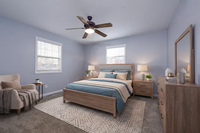 a spacious bedroom with a bed and window