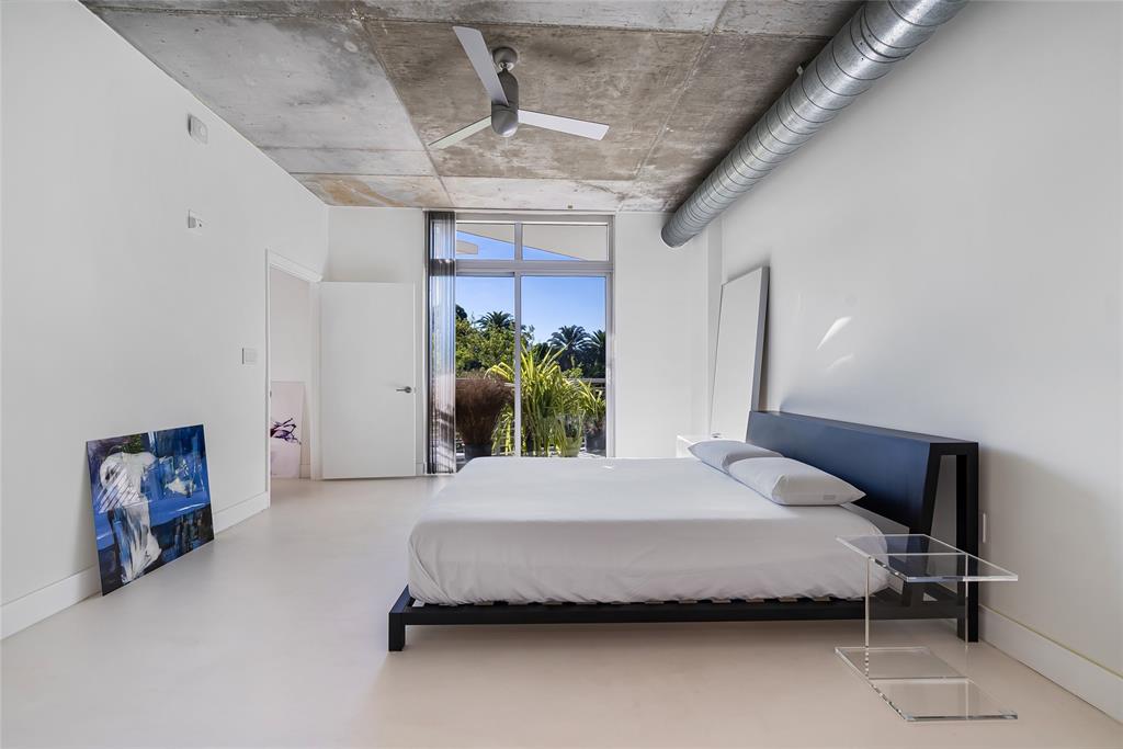 2001 Meridian Avenue, Unit 318 Miami Beach, FL 33139 - Photo 20 of 37 a bedroom with a bed and a chandelier