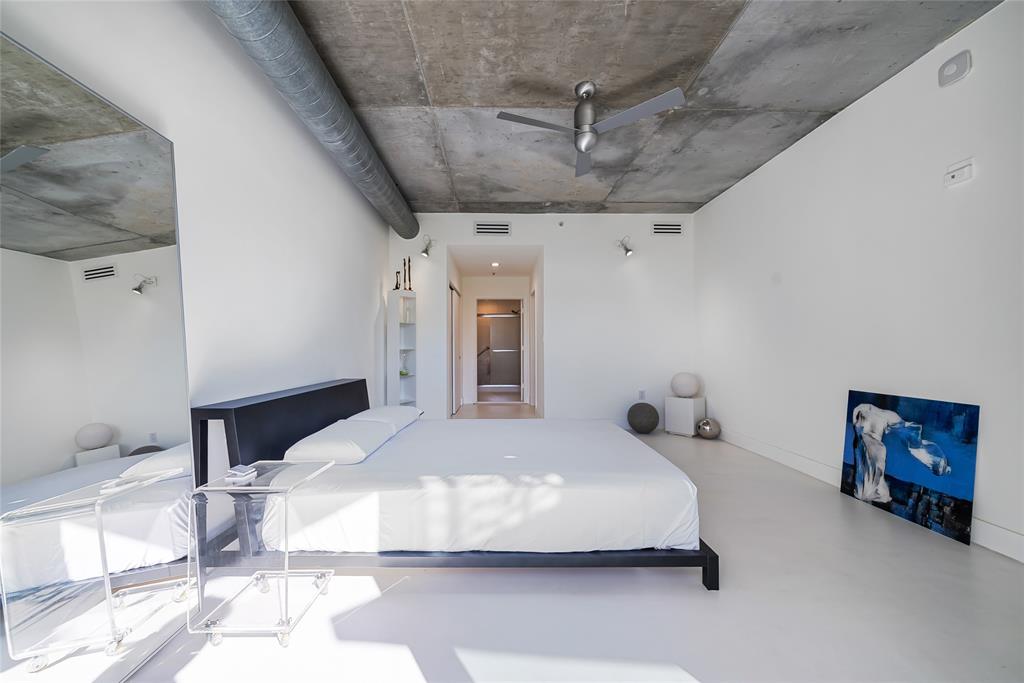 2001 Meridian Avenue, Unit 318 Miami Beach, FL 33139 - Photo 21 of 37 a bedroom with a large bed and a chandelier