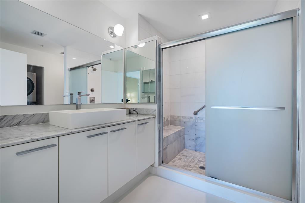 2001 Meridian Avenue, Unit 318 Miami Beach, FL 33139 - Photo 25 of 37 a bathroom with a granite countertop sink a toilet and shower