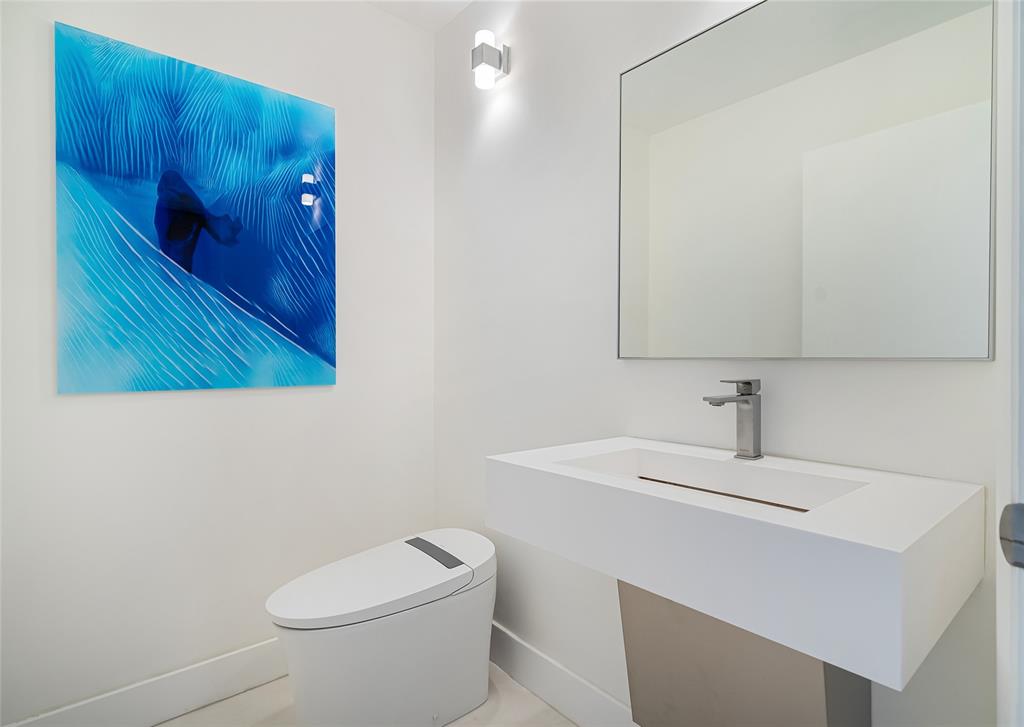 2001 Meridian Avenue, Unit 318 Miami Beach, FL 33139 - Photo 8 of 37 a bathroom with a sink a toilet and mirror