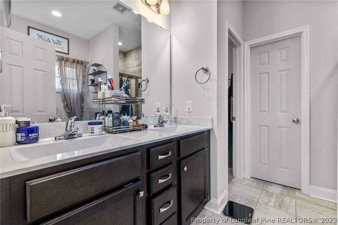 108 Roy's Ridge Raeford, NC 28376 - Photo 17 of 32 a bathroom with a sink a vanity and a mirror