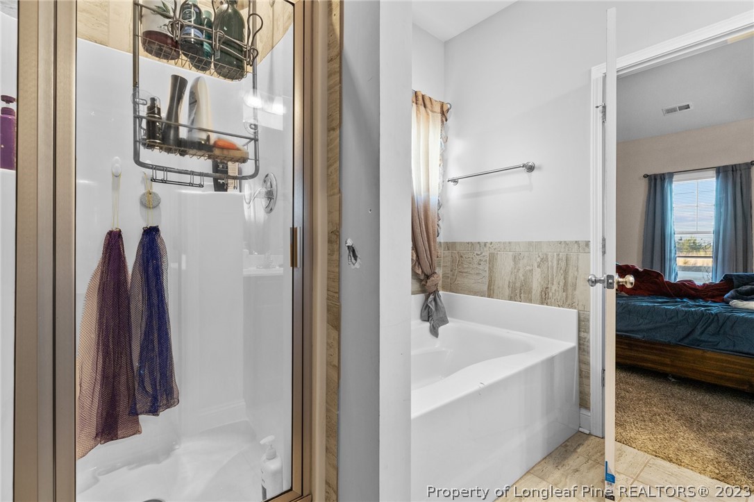 108 Roy's Ridge Raeford, NC 28376 - Photo 18 of 32 a bathroom with a tub and a sink