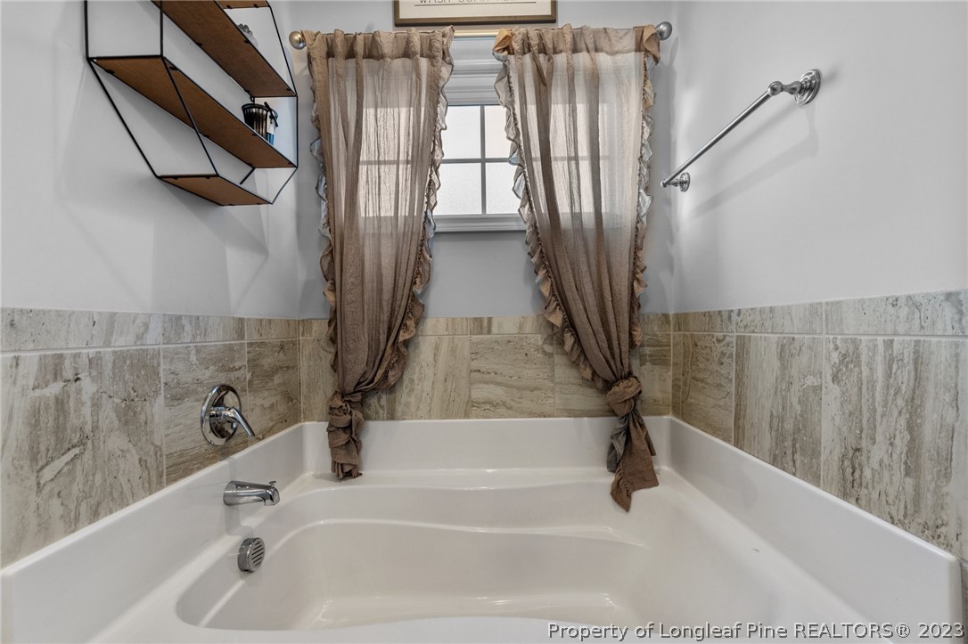 108 Roy's Ridge Raeford, NC 28376 - Photo 19 of 32 a bathroom with a bathtub and a shower