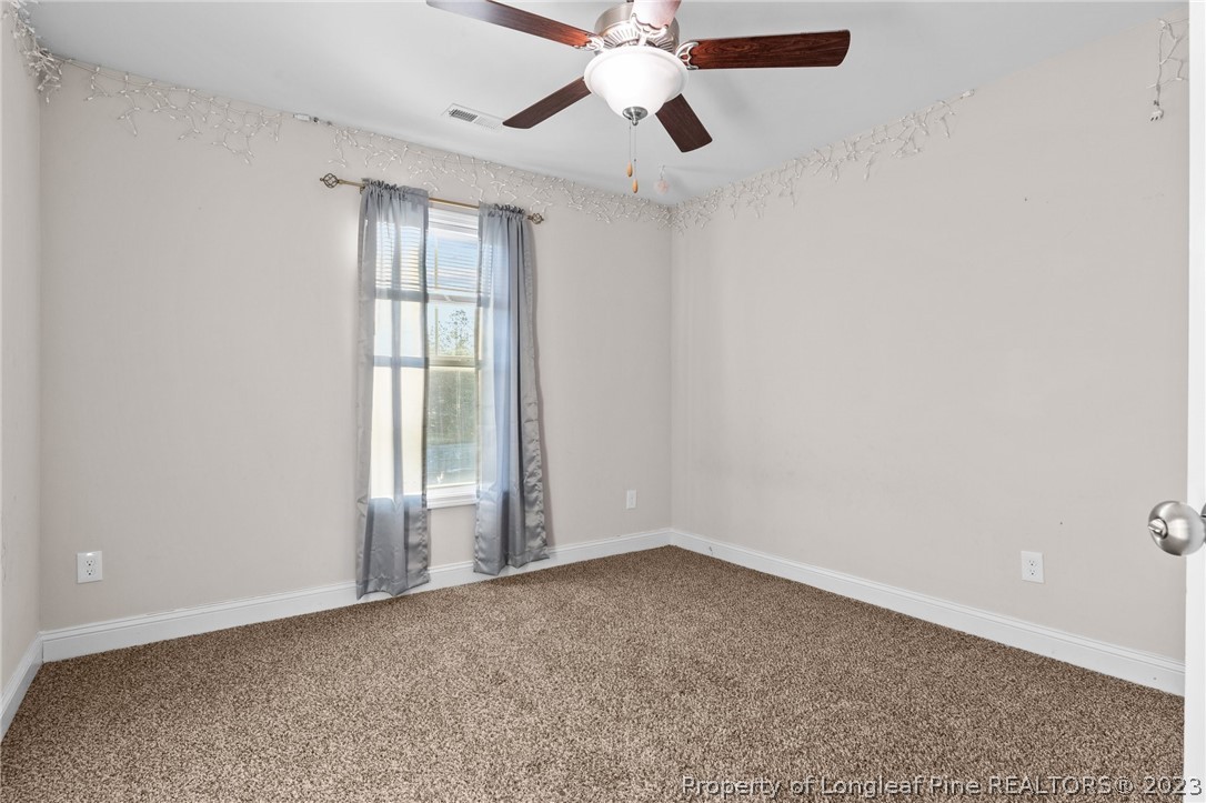108 Roy's Ridge Raeford, NC 28376 - Photo 22 of 32 an empty room with a window and a fan