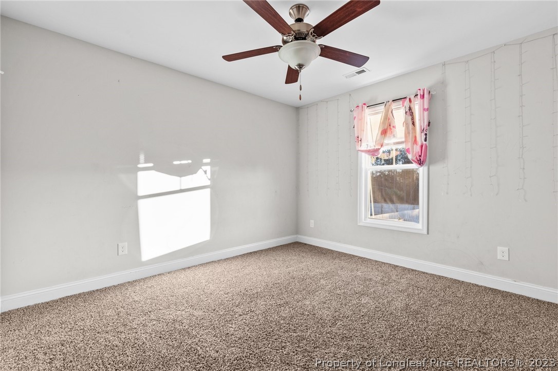 108 Roy's Ridge Raeford, NC 28376 - Photo 26 of 32 an empty room with windows and fan