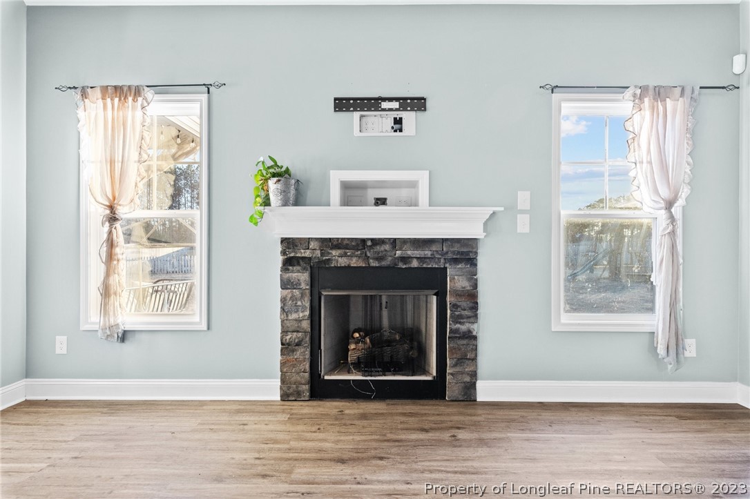 108 Roy's Ridge Raeford, NC 28376 - Photo 7 of 32 a living room with a fireplace and windows