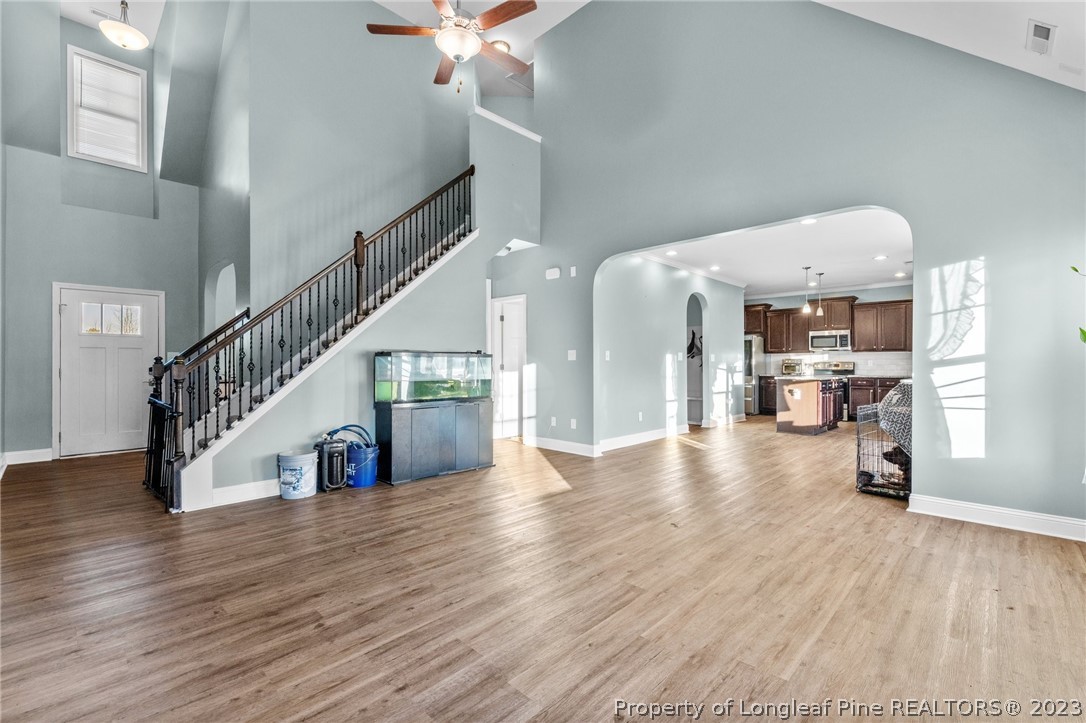 108 Roy's Ridge Raeford, NC 28376 - Photo 9 of 32 a view of a hallway with wooden floor and a kitchen view
