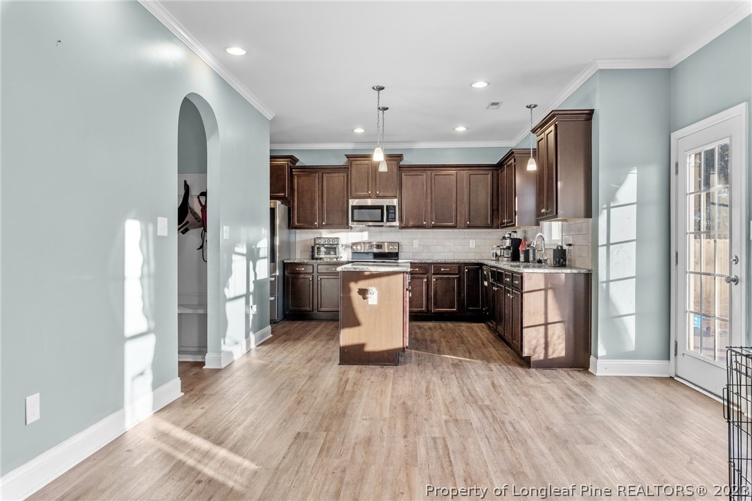 108 Roy's Ridge Raeford, NC 28376 - Photo 10 of 32 a kitchen with stainless steel appliances granite countertop a refrigerator a sink dishwasher a stove and a microwave oven with wooden floor