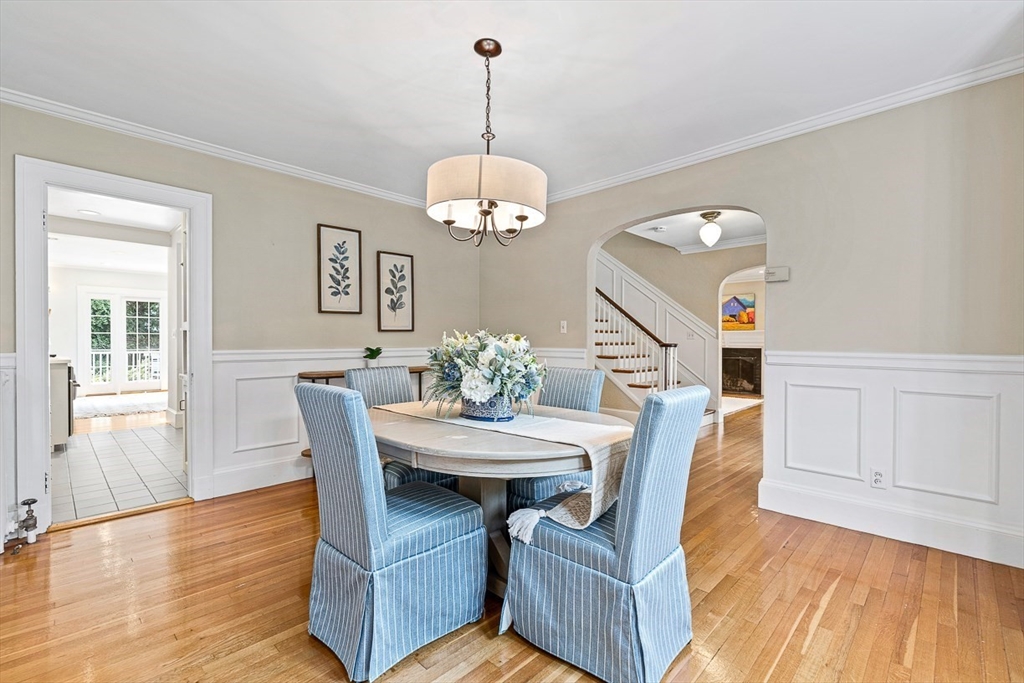 24 Calumet Road Winchester, MA 01890 - Photo 17 of 41 a dining room with wooden floor a chandelier a wooden table and chairs