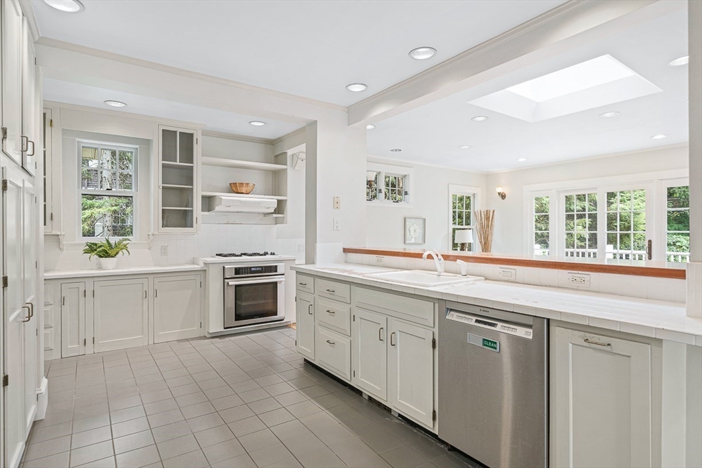 24 Calumet Road Winchester, MA 01890 - Photo 24 of 41 a spacious kitchen with stainless steel appliances granite countertop a stove and a sink