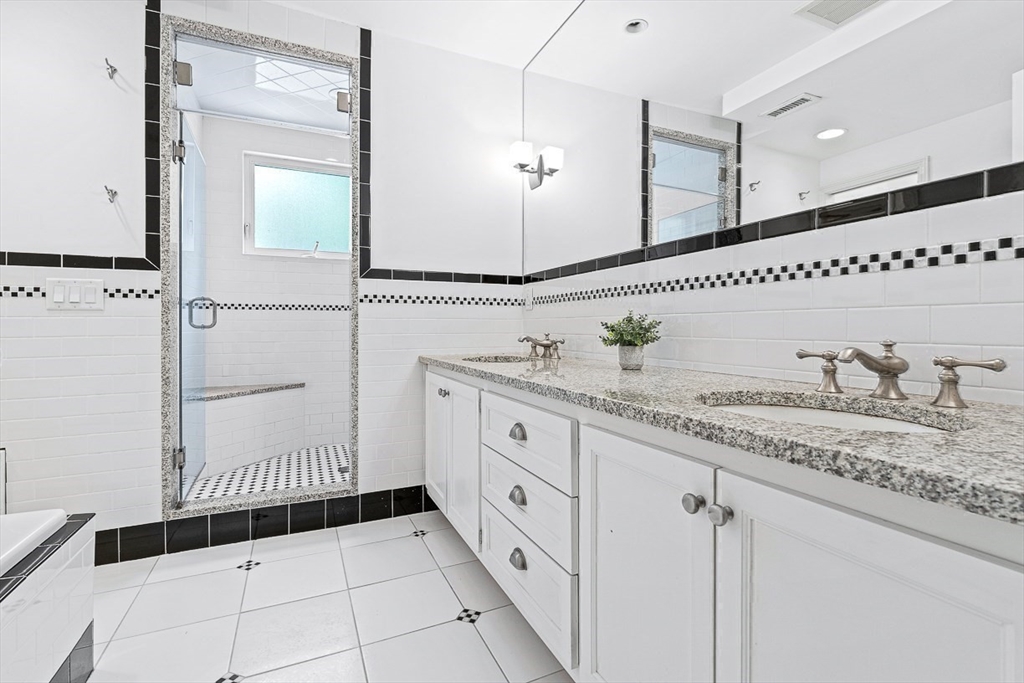 24 Calumet Road Winchester, MA 01890 - Photo 32 of 41 a bathroom with a granite countertop sink and a mirror