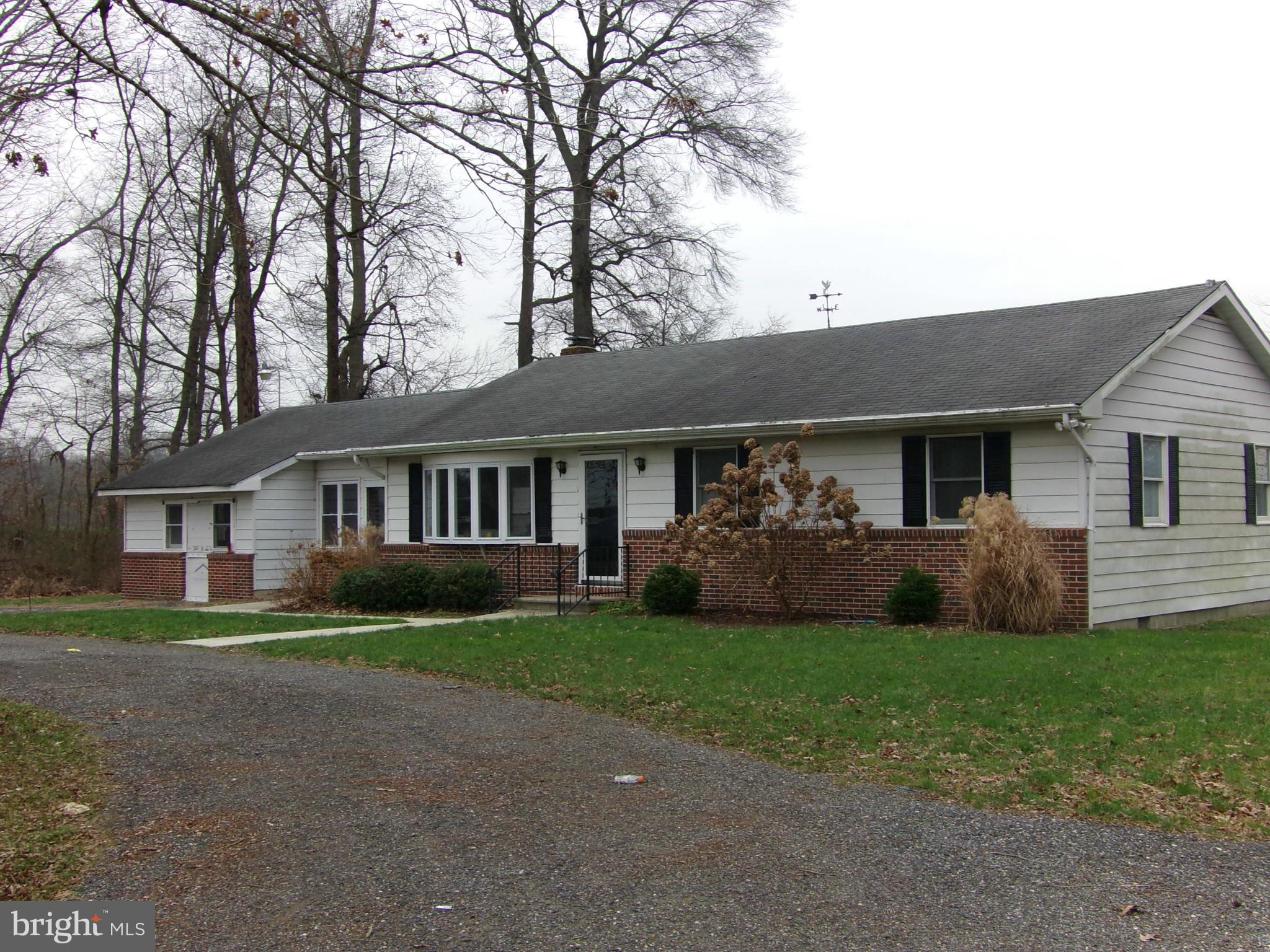 29012 Rabbit Hill Road Easton, MD 21601 - Photo 4 of 22 a front view of a house with a yard and garage