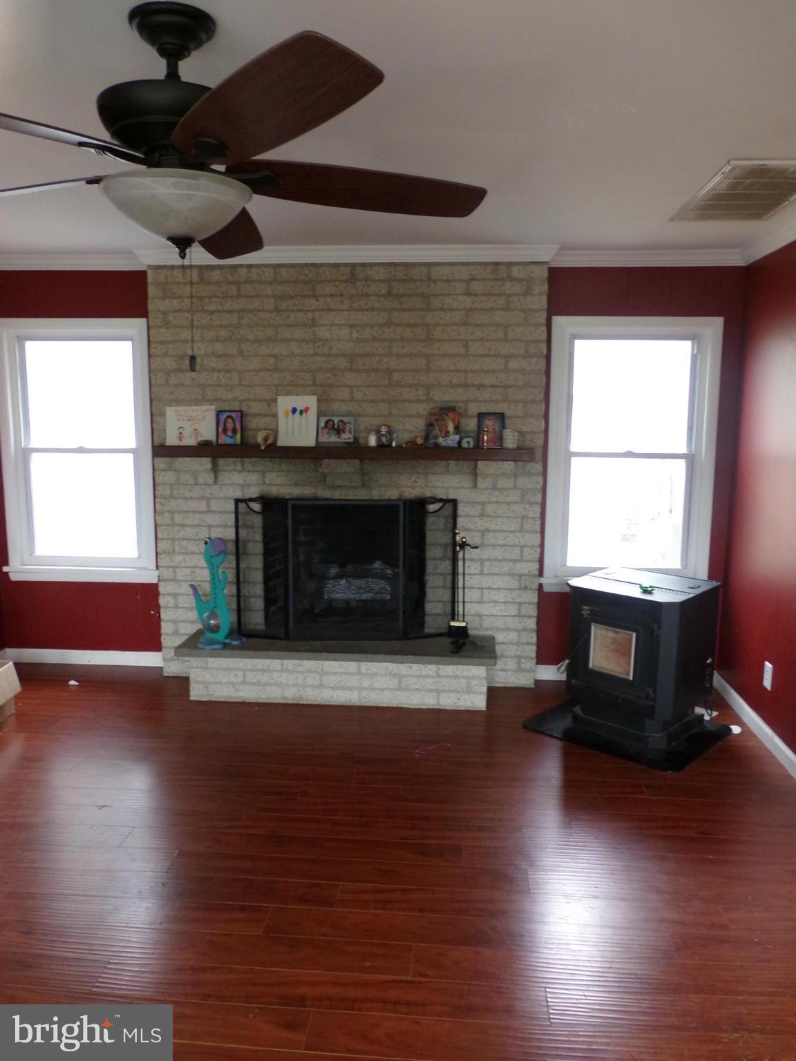 29012 Rabbit Hill Road Easton, MD 21601 - Photo 9 of 22 a living room with hard wood floors and a fireplace