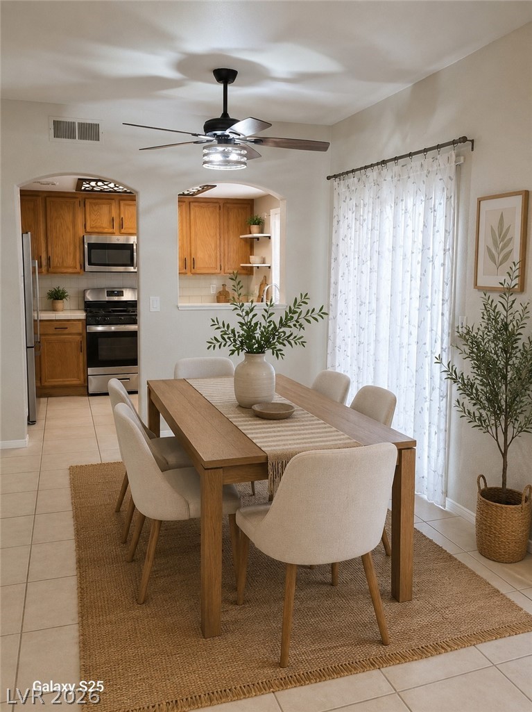 346 Seine Way Henderson, NV 89014 - Photo 7 of 24 An inviting dining area flows into a well-appointed kitchen, ideal for entertaining.