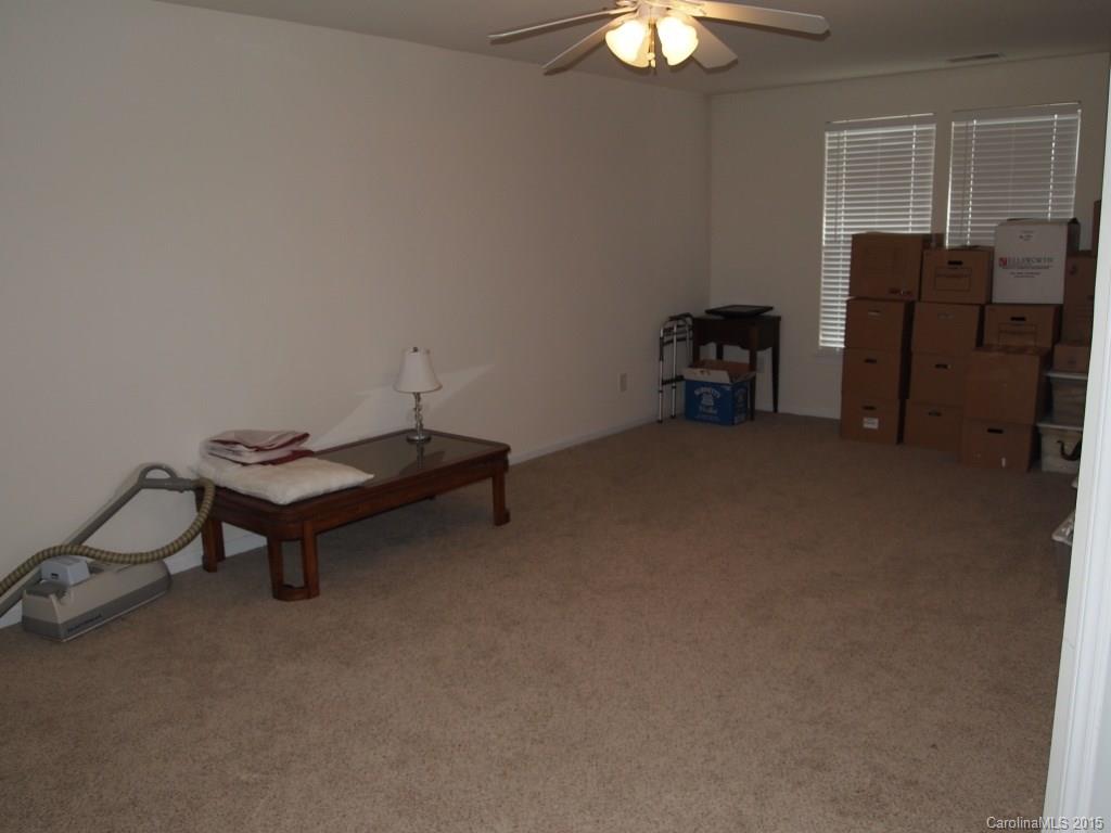 603 Panthers Way, Unit 190 Fort Mill, SC 29708 - Photo 13 of 17 a living room with furniture and a chandelier