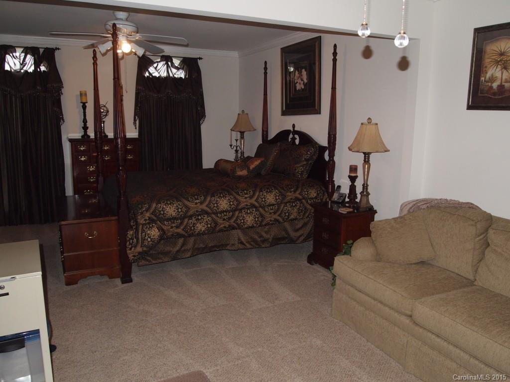603 Panthers Way, Unit 190 Fort Mill, SC 29708 - Photo 15 of 17 a living room with furniture a dining table and a chandelier