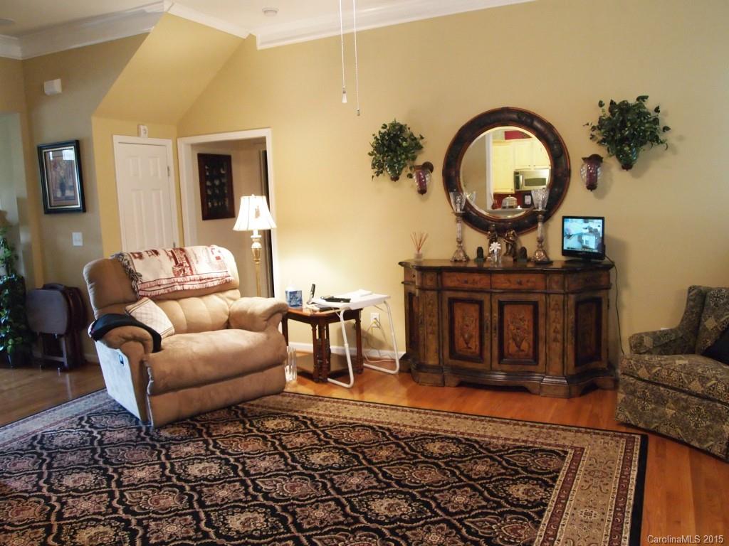 603 Panthers Way, Unit 190 Fort Mill, SC 29708 - Photo 7 of 17 a living room with furniture a mirror and a rug
