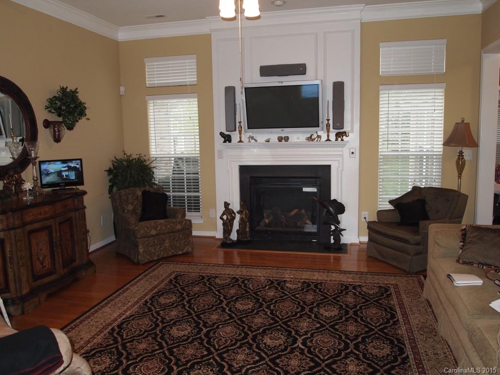 603 Panthers Way, Unit 190 Fort Mill, SC 29708 - Photo 8 of 17 a living room with furniture a flat screen tv and a fireplace