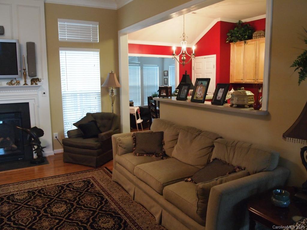 603 Panthers Way, Unit 190 Fort Mill, SC 29708 - Photo 9 of 17 a living room with furniture a flat screen tv and a fireplace