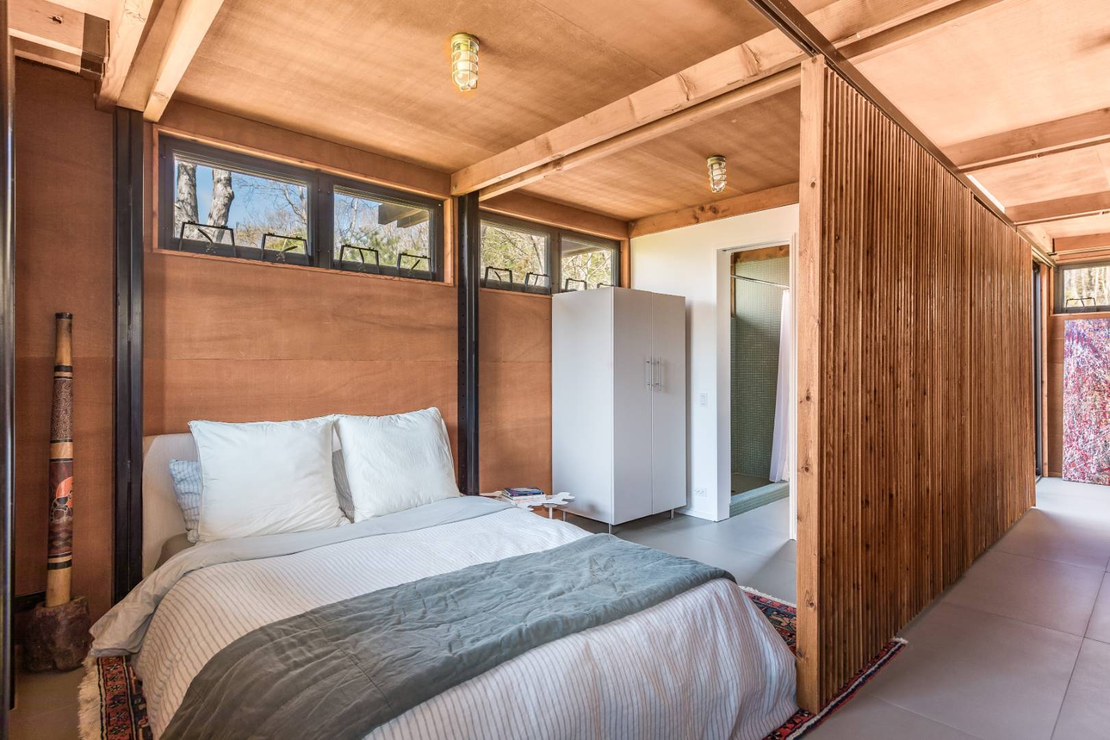 131 Windward East Hampton, NY 11937 - Photo 11 of 22 a bedroom with a large bed and a large window