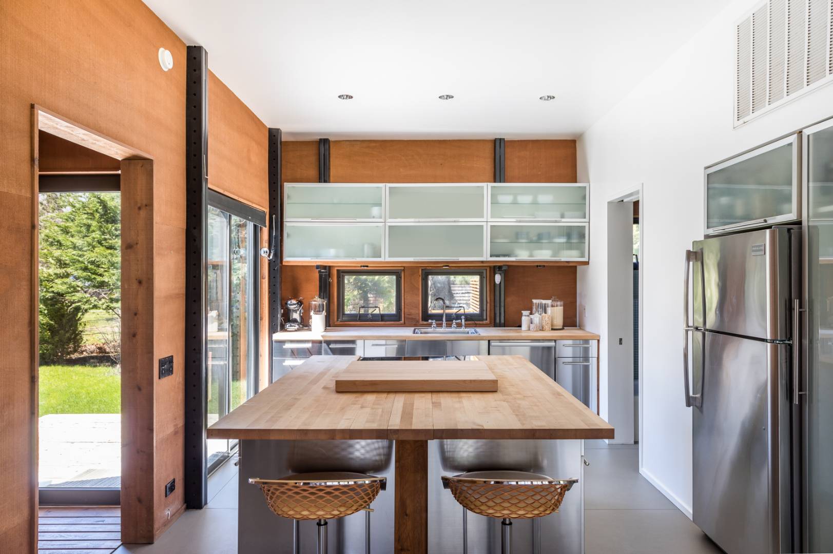131 Windward East Hampton, NY 11937 - Photo 6 of 22 a kitchen with a table chairs and refrigerator