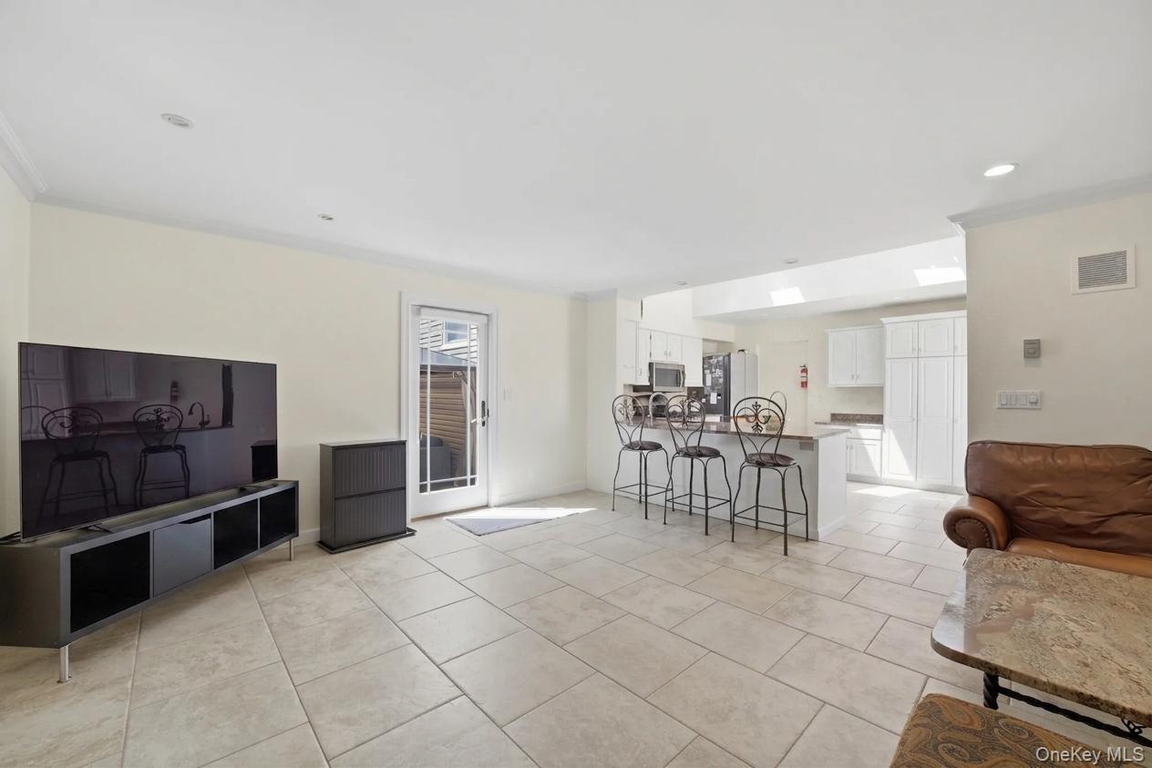 29 Montrose Road Yonkers, NY 10710 - Photo 9 of 39 Spacious room with large format tile flooring, crown molding, and recessed lighting