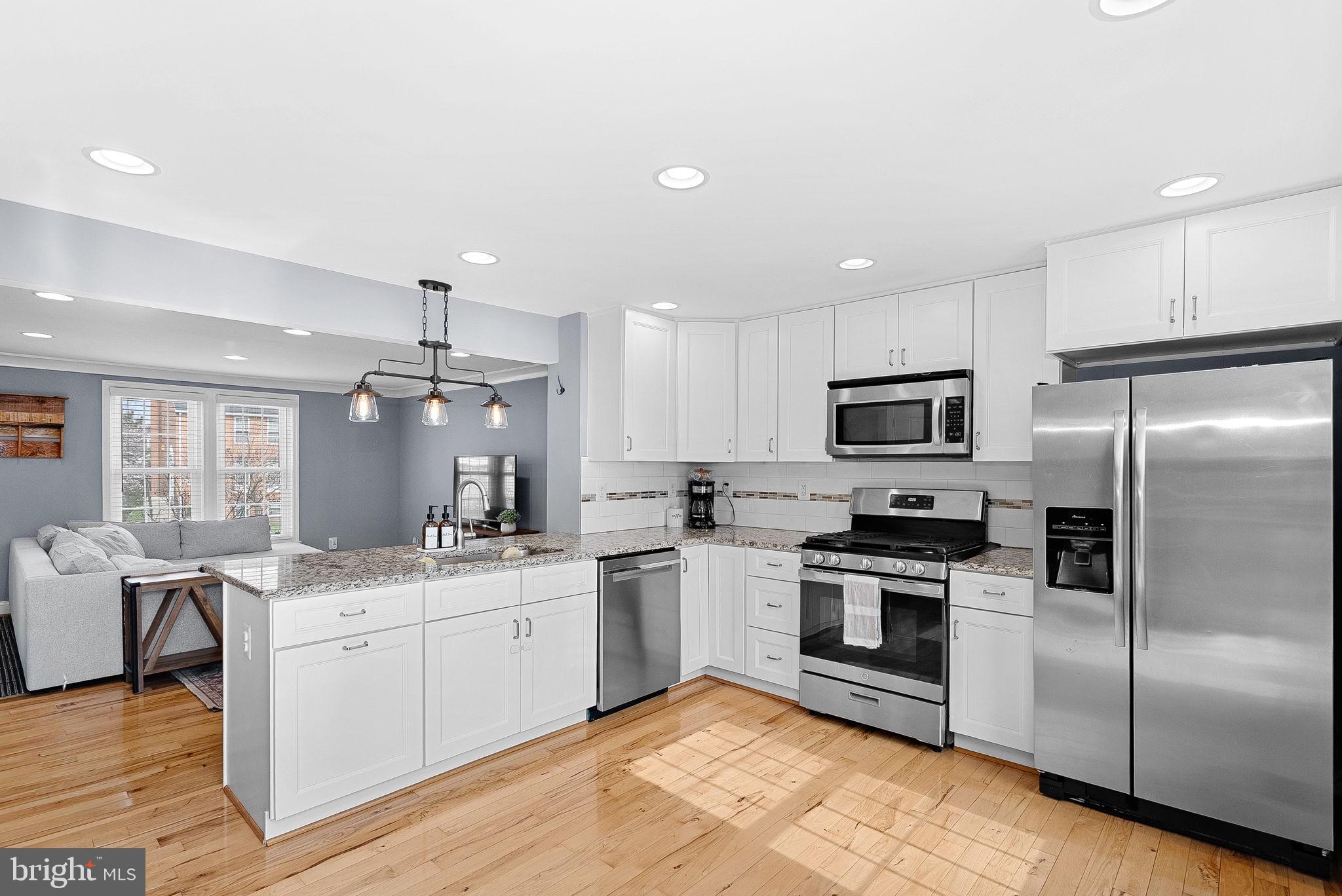 43983 Choptank Terrace Ashburn, VA 20147 - Photo 11 of 43 a kitchen with a sink stainless steel appliances and white cabinets