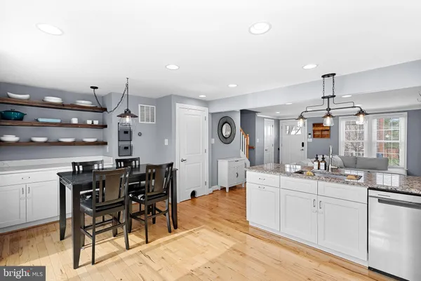 a large kitchen with a table and chairs