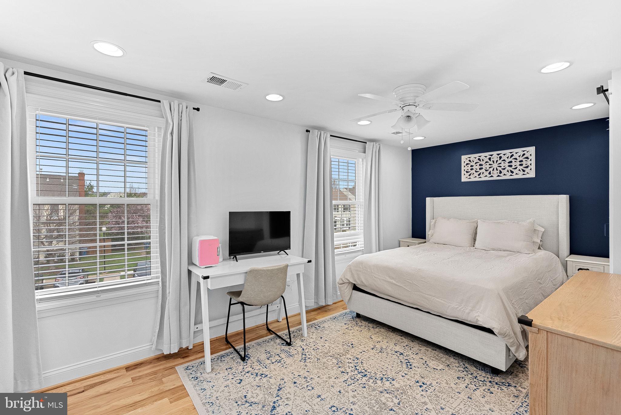 43983 Choptank Terrace Ashburn, VA 20147 - Photo 16 of 43 a bedroom with a bed and wooden floor