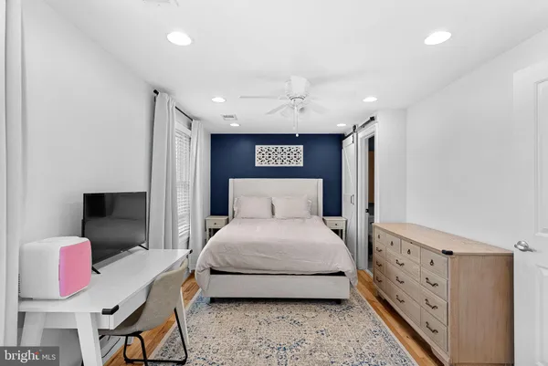 a spacious bedroom with a bed and a desk